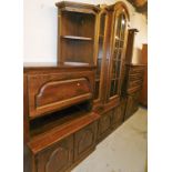 A substantial stained oak wall unit, made up of various sections, to include a central tall