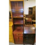 Two items of furniture, comprising a mahogany part wall unit, with bookcase top, marquetry banding