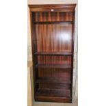 A reproduction mahogany finish bookcase, with five adjustable shelves, 196cm high, 81cm wide, 30cm