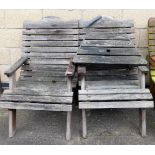 A pair of wooden garden chairs, with central table joining section.