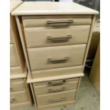 A pair of modern bedside cabinets, with wood finish, each with graduated drawers, with steel