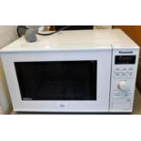 A Panasonic Inverter microwave, NN-SD251W, in white, with instruction manual.