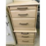 A pair of modern bedside cabinets, with wood finish, each with graduated drawers, with steel