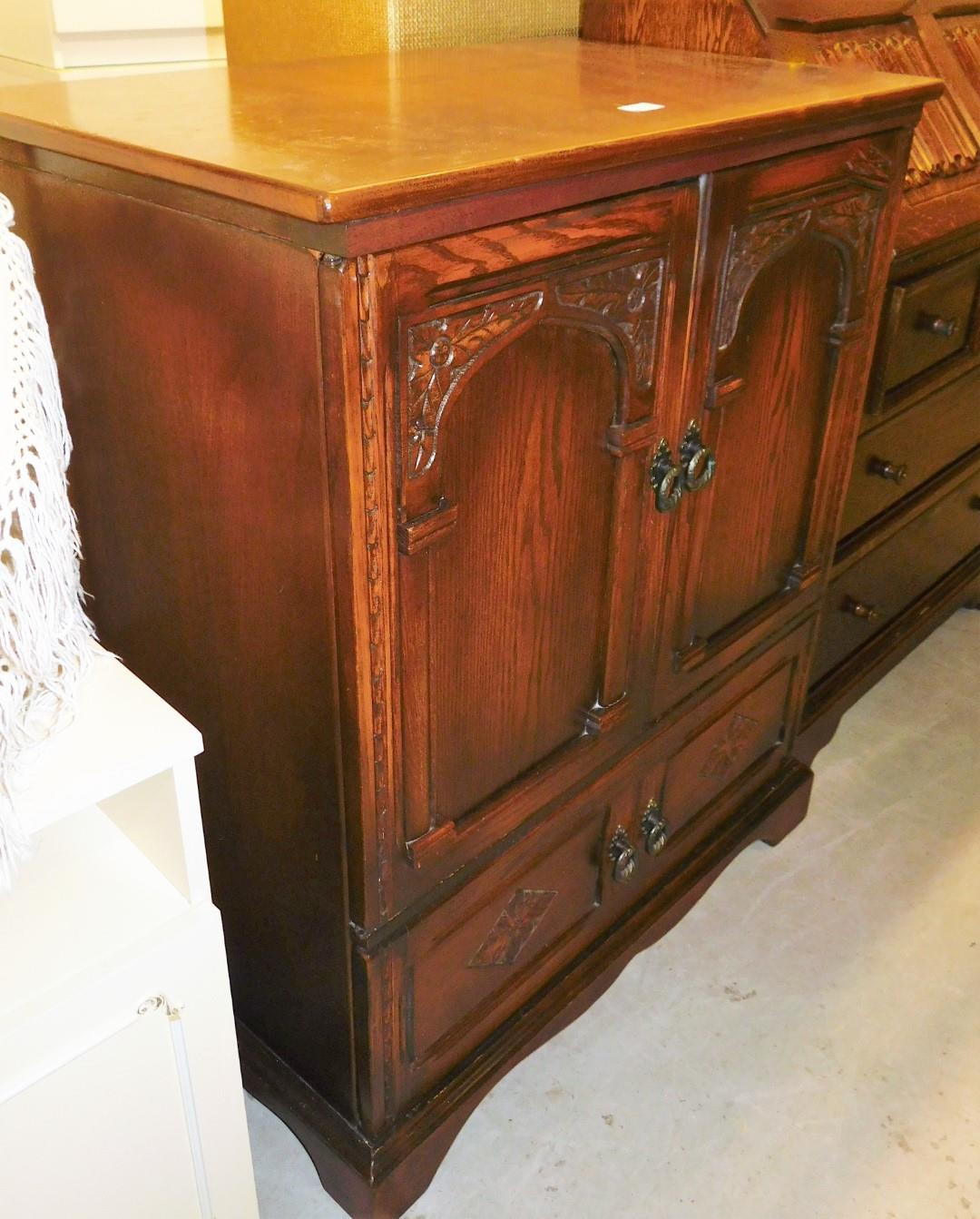 An oak Old Charm TV cabinet, with cupboard top and single drawer to base, 92cm high, 77cm wide, 49cm