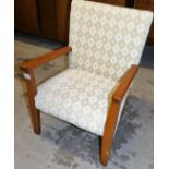 A child's side chair, with beech arms and upholstered in cream patterned fabric. the upholstery in
