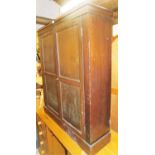 A mahogany finished cabinet, with two doors opening to reveal four shelf section, on a plinth