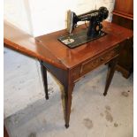 A mahogany framed sewing table with a Singer black sewing machine, the top AF, with drop design