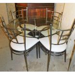 A circular glass topped kitchen table, with silvered metal three splay centre, and a set of four