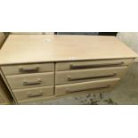 A modern chest of drawers, of three short and three long drawers, with wood finish top, with