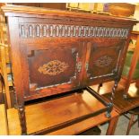 An Old Charm side cabinet, with two door cupboard top, each with brass handle and fret carving, on