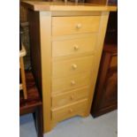 A pine finish six drawer chest of drawers, with arrangement of six short drawers, 110cm high, 58cm