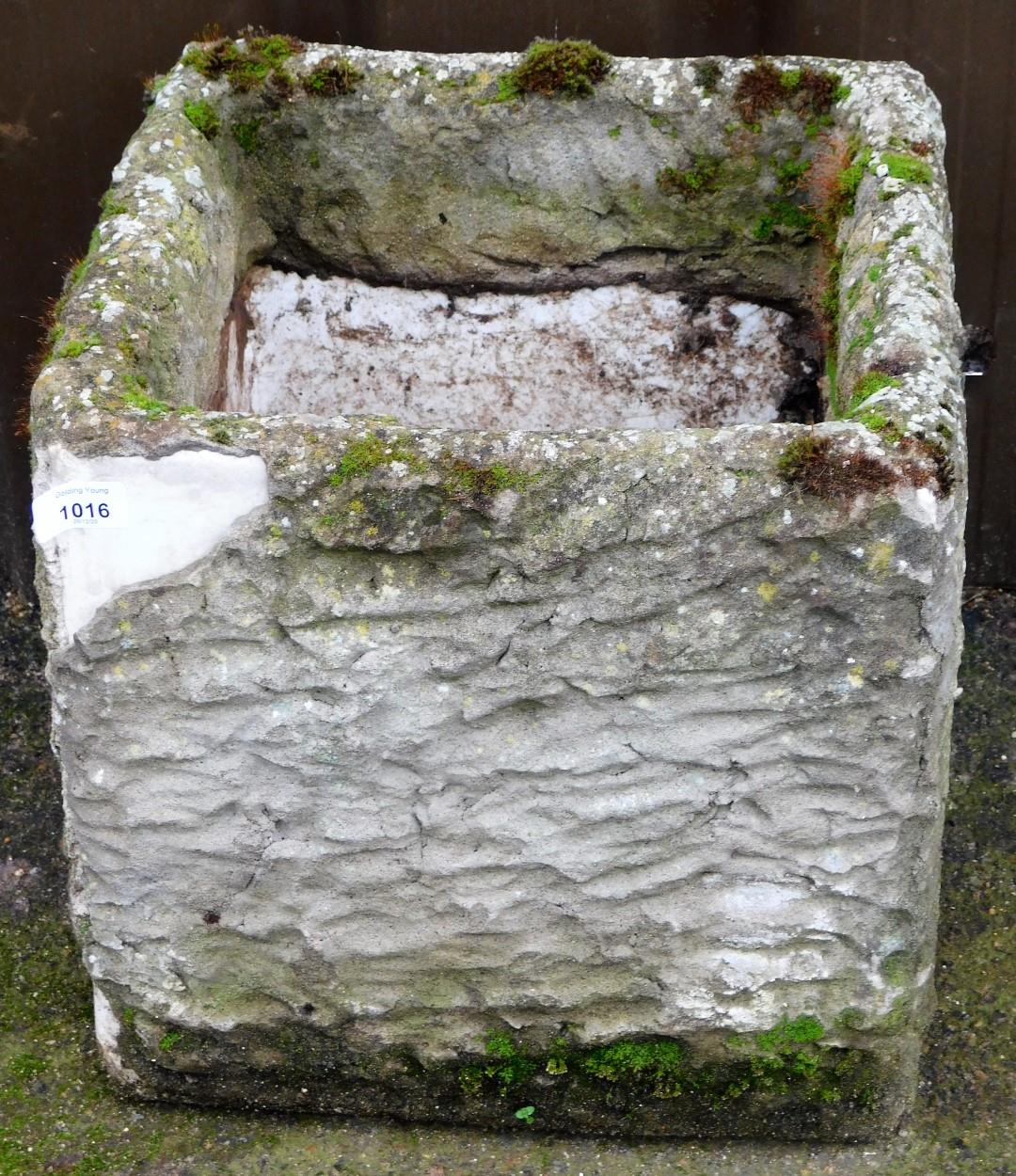 A ceramic planter, over applied with cement.