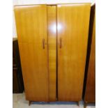 A Wrighton teak wardrobe enclosed by two doors, 108cm wide, 184cm high.