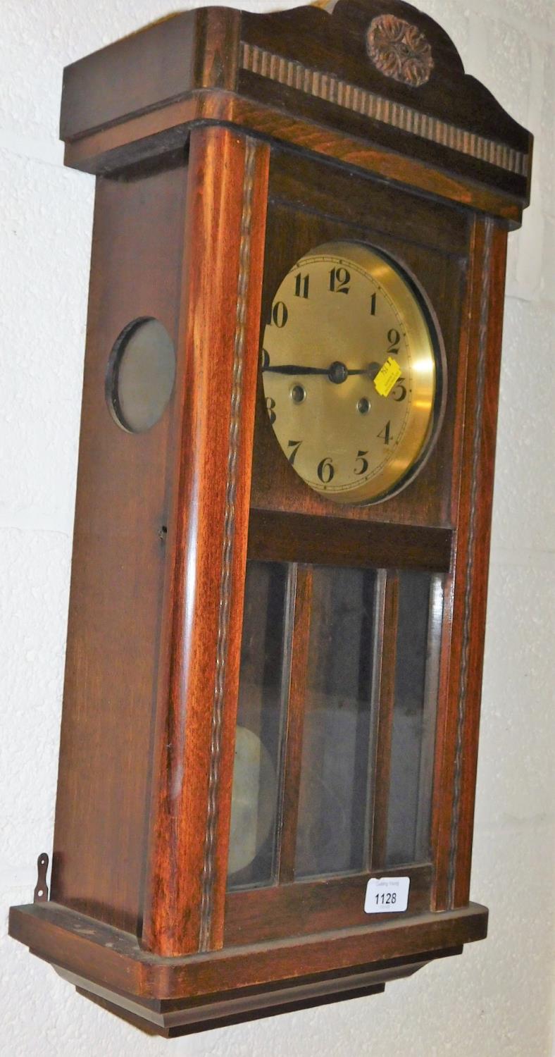 An oak cased wall clock, with Arabic dial and eight day movement.