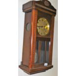 An oak cased wall clock, with Arabic dial and eight day movement.