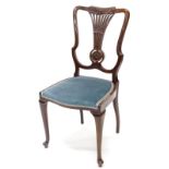 An Edwardian mahogany bedroom chair, the shield shaped back with a pierced splat carved with a