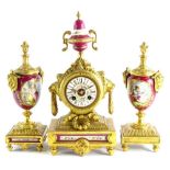A late 19thC French gilt metal and porcelain clock garniture, the clock decorated with an urn