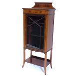 An Edwardian mahogany and satinwood cross banded display cabinet, with a raised back above a