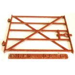 An iron red painted wrought iron five bar gate, with cross stretcher, 83cm high, 94cm wide, and a