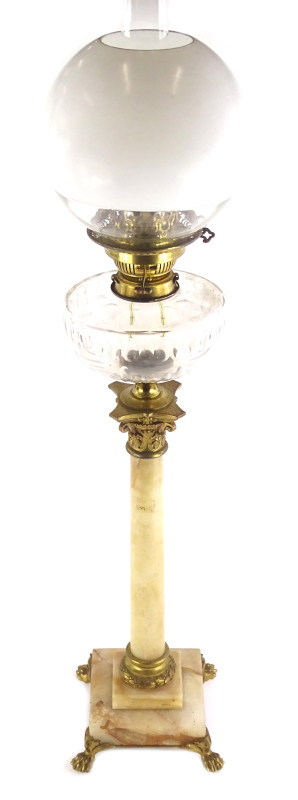 A late 19thC onyx and gilt metal oil lamp, with a later opaque glass globe shade and a clear