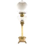 A late 19thC onyx and gilt metal oil lamp, with a later opaque glass globe shade and a clear