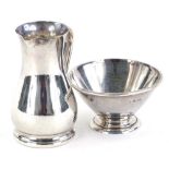 A George V Art Deco silver cream jug and matching sugar bowl, each of plain form and a moulded foot,