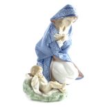 A Lladro porcelain figure of a kneeling lady wearing a cloak, impressed number 2477, 17cm high,