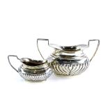 An Edwardian silver two handled sugar bowl, with part fluted decoration, Birmingham 1900, and a