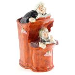 An early 19thC Staffordshire pottery pulpit group, depicting the Vicar and Moses, picked out in red,