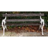 A cast iron slatted garden bench, decorated with berries and leaves, 189cm long.