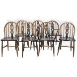 A set of seven Ercol stained beech Windsor type kitchen chairs, each with a pierced splat, a solid