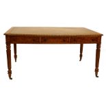 An early Victorian walnut writing table, the rectangular top with a green tooled leather insert
