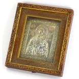 A silver coloured pressed metal icon, in a gilt frame, 20cm x 17cm.