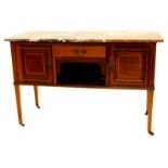 An Edwardian mahogany washstand, with a brown grey and white marble top, above a frieze drawer and a