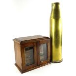 An early 20thC oak smoker's or tobacco cabinet, with a fitted interior of drawers and a glazed