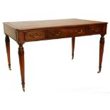 A mahogany writing table in early 19thC style, the rectangular top with a brown leather inset and