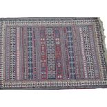 A Soumak flat weave rug, with a striped design, one wide and two narrow borders, 152cm x 102cm.