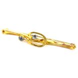 A bar brooch, with two pale blue stones and twist and loop central design, yellow metal, unmarked,