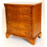A yew veneered chest of drawers, the cross banded top with a moulded edge above four drawers with