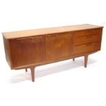 A 1970s/80s teak retro sideboard, with two doors and three drawers on square tapering legs, 170cm