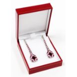 A pair of Art Deco style ruby and diamond drop earrings, the design with various baguette and