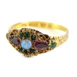 A Victorian dress ring, set with opal, emerald and amethyst, with filigree type scrolling and etched