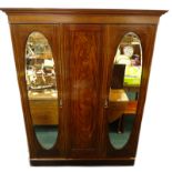 An Edwardian mahogany and satinwood crossbanded triple wardrobe, with a moulded cornice above two