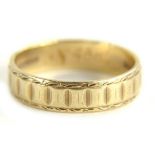 A 9ct gold wedding band, with hammered and engraved design band, ring size O, 2.7g.