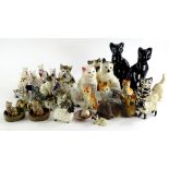 A collection of ceramic cats, to include a Wade examples, Royal Doulton Siamese cat, Staffordshire