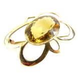 A 9ct gold cluster brooch, with central oval citrine, in floral design frame, on single pin back,