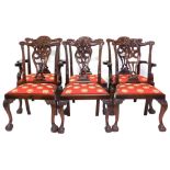 A set of six mahogany dining chairs in George III style, each with a profusely carved back, a