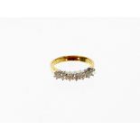 An 18ct gold half hoop diamond eternity ring, set with seven round brilliant cut diamonds, each in