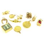 A group of 9ct gold and other charms, comprising a 9ct gold miners lamp, set with red cabochon