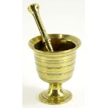 A 19thC chalice shaped bronze pestle, with ribbed decoration and a turned pestle with a mortar, 13cm